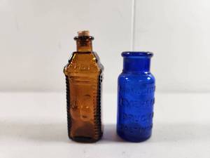lot 140 image: Colored Glass Medicine Bottles Set