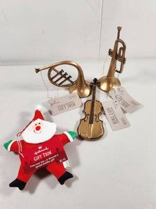 lot 228 image: Hallmark Christmas Ornament Set Musical Instruments and Santa