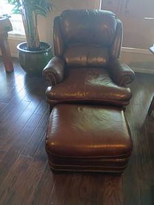 lot 904 image: Hancock and Moore Brown Leather Chair with Ottoman.  Seat 21 x 27.  Ottoman 16 x 25 x 21.  Located in Basement with Walkout
