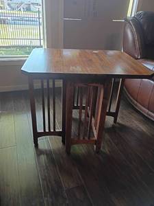 lot 905 image: Wooden Side Table.  Both sides fold down or can be one side.   With both sides up 26 x 32 x 36.  Sides down 26 x 13 x 26.  Located in Basement with Walkout