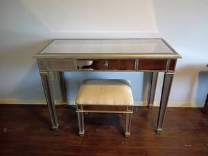 lot 926 image: Mirrored Desk with One Drawer and a Mirrored and Upholstered Stool.  Desk 31 x 42 x 18.  Located in Basement with Walkout