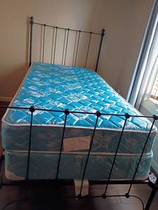 lot 929 image: Twin Sized, Wrought Iron Bed Frame with Mattress and Box Springs.  Headboard 51 x 42.  Footboard 35 x 42.  Located in Basement with Walkout
