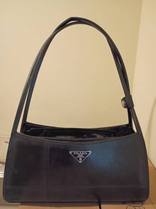 lot 944 image: Black Leather Prada Handbag