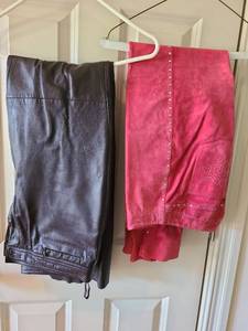 lot 1013 image: Womens black leather pants andstudded red suede pants, both size 8.