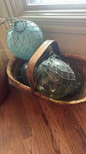 lot 1103 image: Handblown Glass balls with netting around them in wicker basket with handle