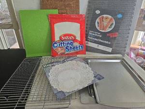 lot 1289 image: Cookie sheets, cooling racks, disposable cutting sheets, perforated breadstick pan