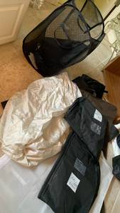 lot 1699 image: Travel folding laundry basket with closet garment bags