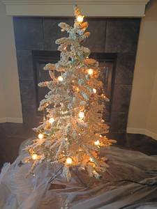 lot 2005 image: 4ft. tall Flocked Christmas Tree with Lights and Ornaments.  Located in Basement with Walkout