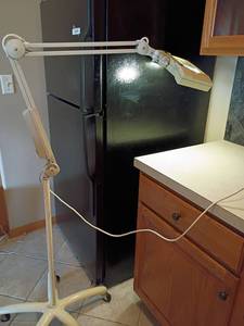 lot 2018 image: Luxo Adjustable Lamp. With Magnifier.   Tall as 67in. With Base 24in.  Located in Basement