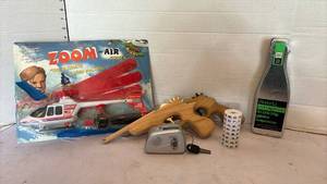 lot 3155 image: Toy helicopter, rubber band guns and a drinking game