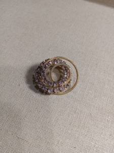 lot 50252 image: Gold Tone Circular Brooch with Purple Rhinestones
