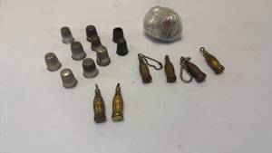 lot 1027 image: Thimbles, Coca Cola key chains and marbles