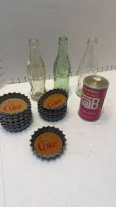 lot 1033 image: Coca Cola coasters, glass bottles and Tab tin radio