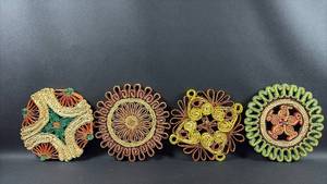 lot 82 image: Set of 4 Vintage Handwoven Straw Fiber Trivets with Floral and Spiral Designs