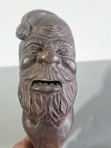 lot 107 image: $$ antique German or Swiss Black Forest nutcracker carved from wood, likely dating to the late 19th or early 20th century.