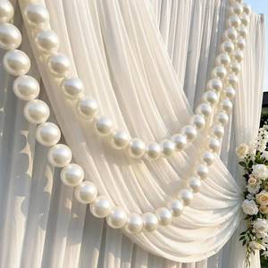 lot 1594 image: Canlierr 2 Pcs 6.5ft Wedding Giant Pearl Garland Decorations 60mm Large Faux Bead Garland with Hook for Ceremony Photo Booth Outdoor Proposal Scene Garden Beach Party Decor (Ivory White, Simple)