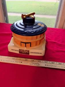lot 23 image: Ezra Brooks Wichita Centennial Whiskey Decanter with Airplane Stopper