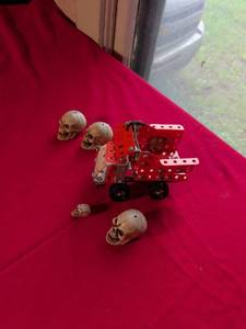 lot 25 image: Red Metal Erector Set Truck with Skull Figurines