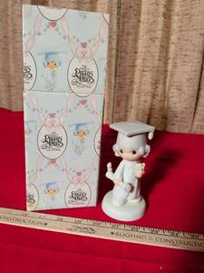 lot 34 image: Enesco Precious Moments The Lord Bless You And Keep You Graduate Figurine E-4721