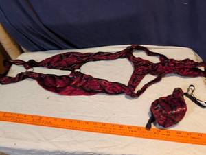 lot 223 image: Mens Red Snakeskin Print Suspender Thong and woman lingerie by Fredericks of Hollywood.