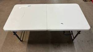 lot 2042 image: Folding White Plastic Table with Metal Legs 4��Long 2��Wide