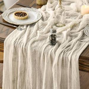 lot 43241 image: Artoid Mode Boho Cheesecloth Gauze Beige Wedding Table Runner, 120 Inch Seasonal Fabric Kitchen Dining Holiday Table Decor for Home Party Indoor - Retail $10