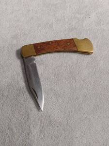 lot 6140 image: Stainless Steel Folding Pocket Knife with Wood Handle and Brass Bolsters