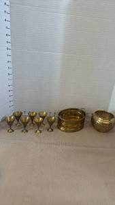 lot 1005 image: Brass shot glasses, and brass candle holder