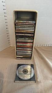 lot 1162 image: Mixed CD Lot of 30 with Storage Holder - Enya, Louis Armstrong, Beach Boys, Motown & More