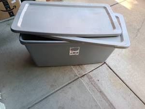 lot 3153 image: 2 Sterilite totes with lids, 50 gallon. One lid has crack on rim.