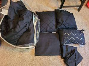 lot 7118 image: Black comforter, dust ruffle, throw pillows, pillowcases.