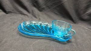 lot 818 image: Blue Glass Teacup and Saucer Set with Shell Pattern - Manganese Glow