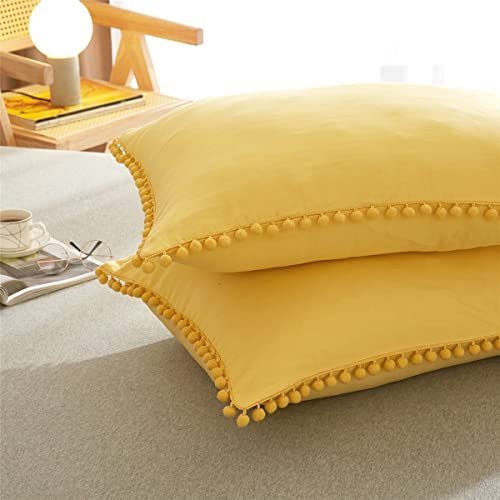 lot 2084 image: TanNicoor Pom Fringe Pillowcases,Yellow Tassel Ball Pillow Sham Set of 2,Standard Queen Pillow Covers with Envelope Closure End,20x26 Retail $22.49