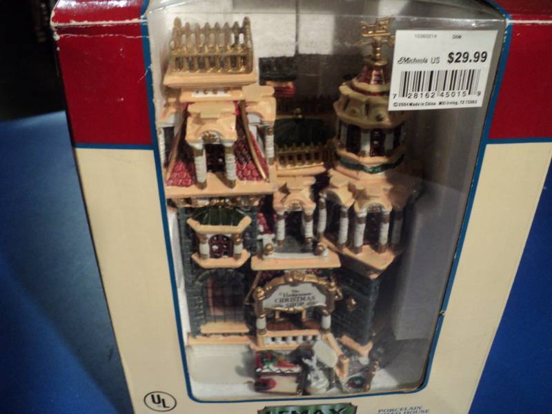 lot 4381 image: LeMax Village Collection Porcelain Lighted House The Victorian Christmas Shop Open box, appears complete