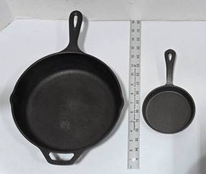lot 561 image: Cast Iron Skillets,  Lg is marked Lodge and sm is unmarked