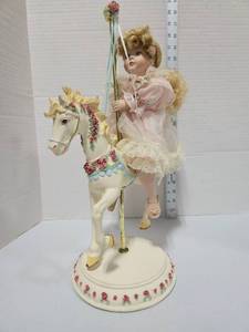 lot 639 image: Porcelain Girl Doll on Carousel Horse Figurine