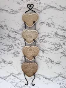 lot 134 image: Vintage Pampered Chef 4-Piece Stoneware Cookie Molds with Display Hanger
