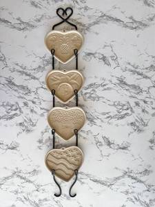 lot 135 image: Vintage Pampered Chef 4-Piece Stoneware Cookie Molds with Display Hanger