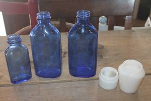 lot 1387 image: Vtg. Blue Glass Phillips Milk of Magnesia Bottles & More