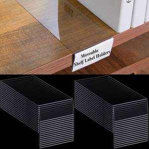 lot 26103 image: Containlol 50 Pcs Moveable Shelf Label Holders, Clear Bookshelf Label Library Shelf Markers Bookshelf Divider Tags for Library Office Classroom Home(3 x 1.6 Inch) - Retail $25