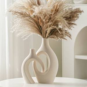 lot 7908 image: Lvases Snuggle Hollow Ceramic Vase Set of 2, Boho ins Style Round Nordic Mid Century Modern Aesthetic Decorative Vase for Home Decor (Cream W 6.8 X H 11)