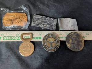 lot 292 image: Lot of 5 Assorted Metal Belt Buckles and Fob - Melroe, Spirit of 76, Warsteiner, Rain For Rent