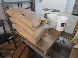 lot 12600 image: Grain Millers Rolled White Wheat Flakes 50 lb Bags and Briess Malt and Ingredients bags.