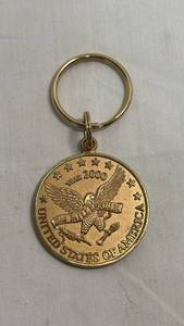 lot 57 image: Year 2000 Millennium United States of America Gold-Tone Coin Keychain by Blackinton & Co.