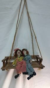 lot 92 image: Porcelain Clown Doll Pair on Wooden Porch Swing