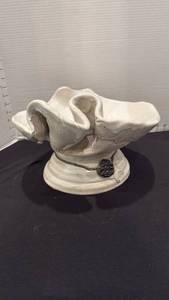 lot 1008 image: Pottery bowl with a creamy white finish with distinctive ruffled edges and decorative metal seal 7x12