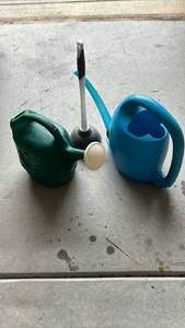 lot 3004 image: Plastic Watering Cans Set of 2 and a plunger