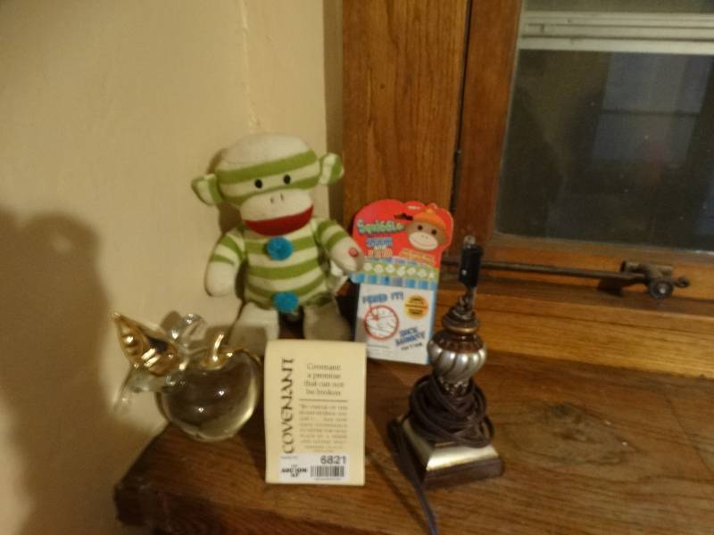 lot 6821 image: Lot with home decor, sock monkey game, dancing sock monkey and a lamp has no lamp shade.