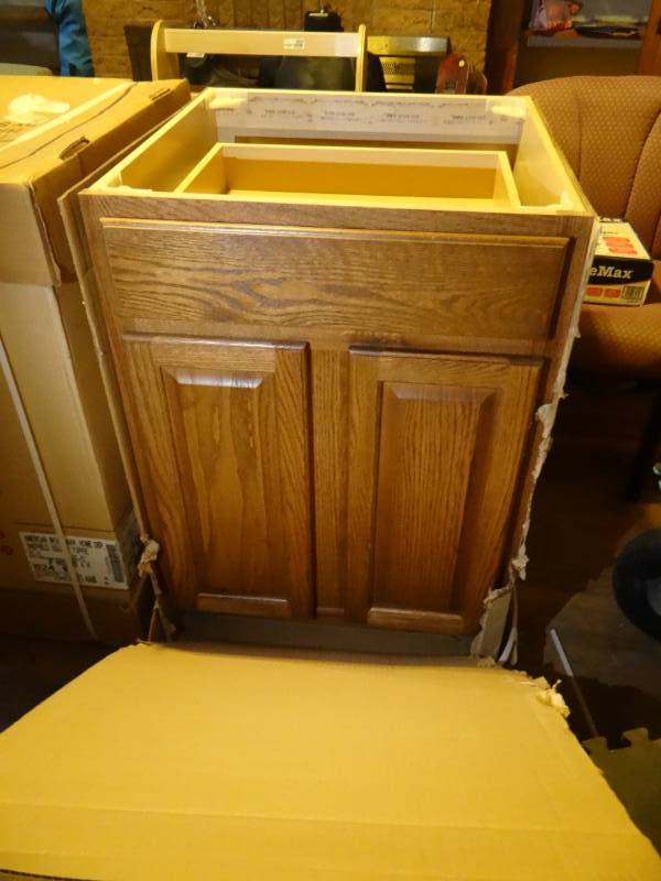 lot 6938 image: Brand new 24 american woodmark chief filed square toffee kitchen and bath cabintry.
