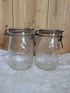 lot 2504 image: Embossed Glass Bail Top Canning Jars Set of 2
